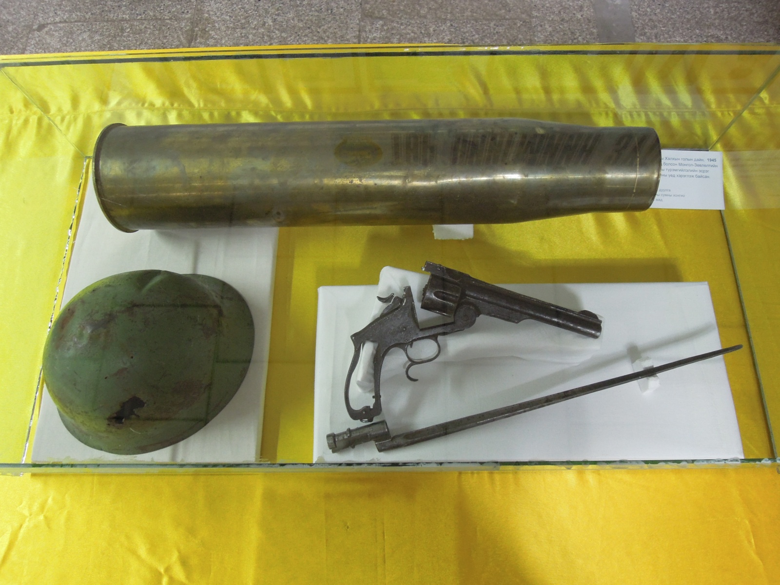 Murun - Museum - WW2 helmet, shell case and revolver