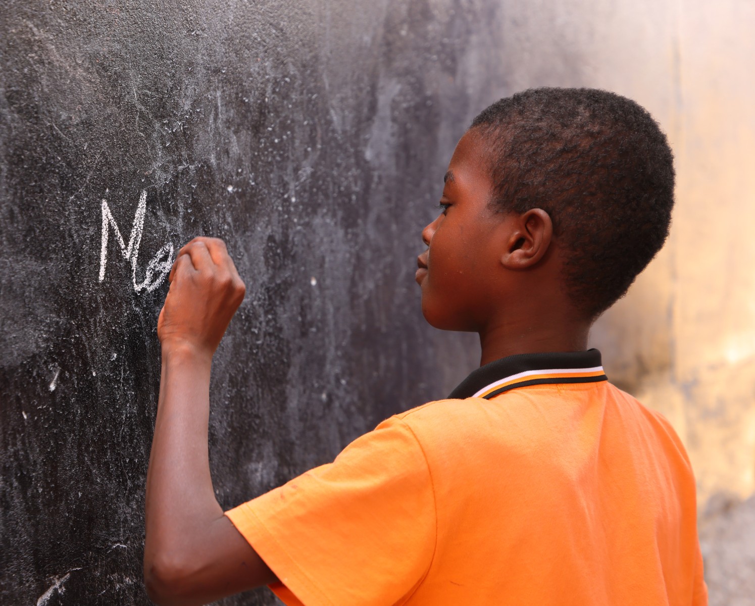 On the road to Saint Louis - School - Schoolboy writing on the blackboard